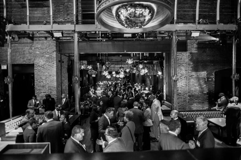 Black and white picture of a reception with brick walls